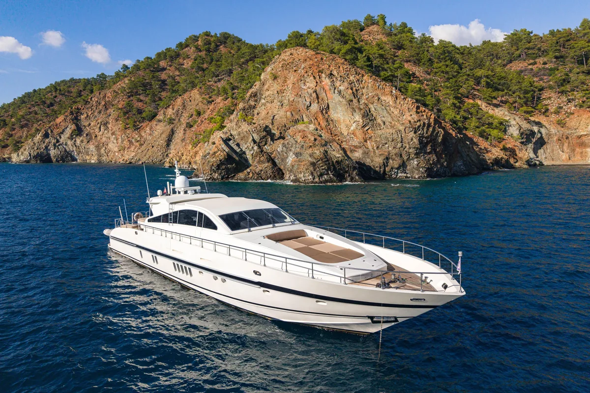 Leopard 80 sport yacht anchored below rocky cliffs